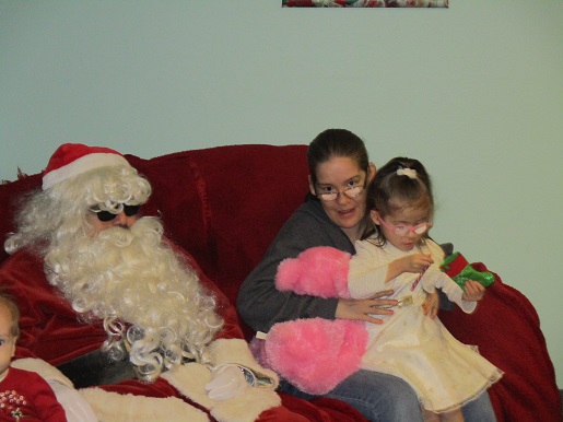 Santa posing with a Mother and Daughter